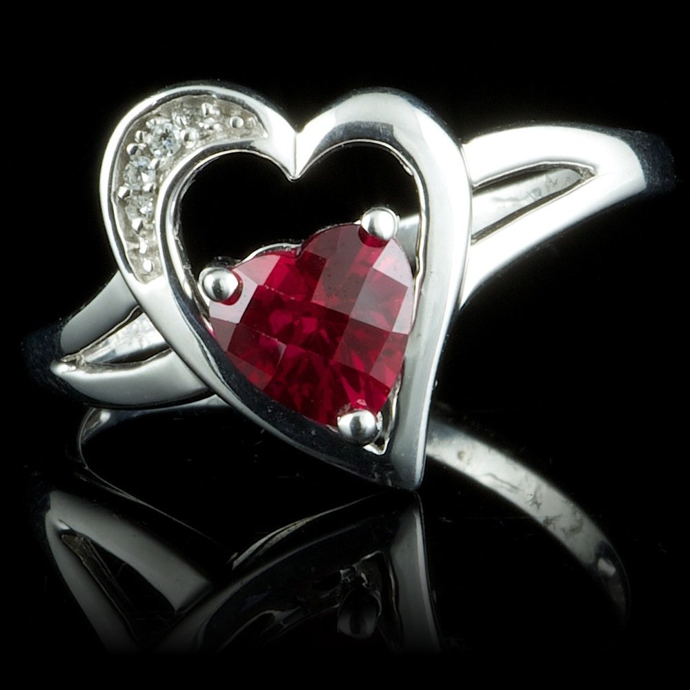925 Sterling Silver 0.75ct Ruby 09ct Diamond Ring: Retail: $100.00 Metal: .925, Sterling Silver Size: 7.5 Total Item Weight: 2.9 grams Main Stone: Ruby Color: Red Carat Total Weight: 0.75 Treatment: Created Clarity: Type 2 Cut: Very Good Secondary Sto