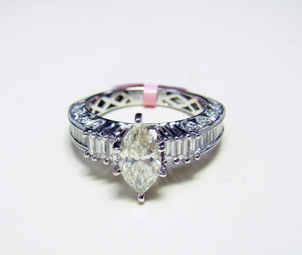 18KT Gold, 1.87ctw Diamond Solitaire Ring: CERTIFIED with AIG an 18KT White Gold, NATURAL 1.01ct Marquise Shaped Cut SI2-Very Light yellow Center Diamond, Surronding with 0.86ctw of Round Brilliant/Baugette (VS1-SI1, G-H) Side Diamonds, Ladies