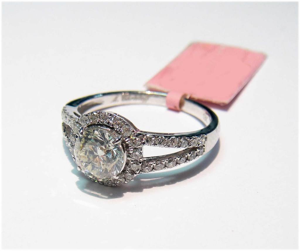 18KT White Gold, 1.43ct Diamond Solitaire Ring: CERTIFIED with AIG an 18KT White Gold, NATURAL 0.96ct Round Brilliant SI1 Color I Center Diamond, surrounding with 0.47ctw Round Brilliant SI-2-I2 Color F-H Diamonds. Ladies Solitaire Style Ring. Tota