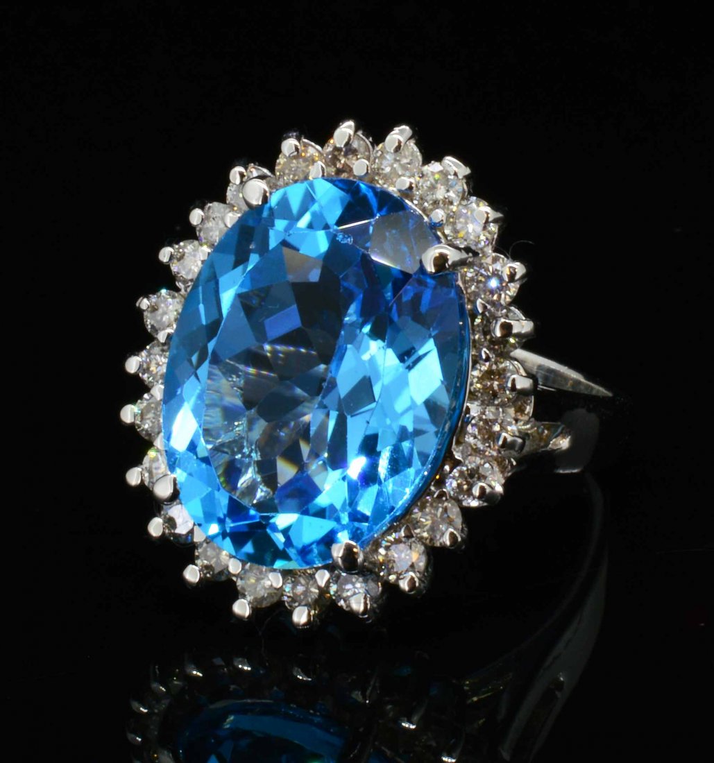 14KT Gold, 11.60ct Blue Topaz & 0.77ct Diamond Ring: 14KT Gold, 11.60ct Blue Topaz & 0.77ct Diamond Ring. Total Weight of Ring: 7 grams. Certificate of Appraisal is included! A1980