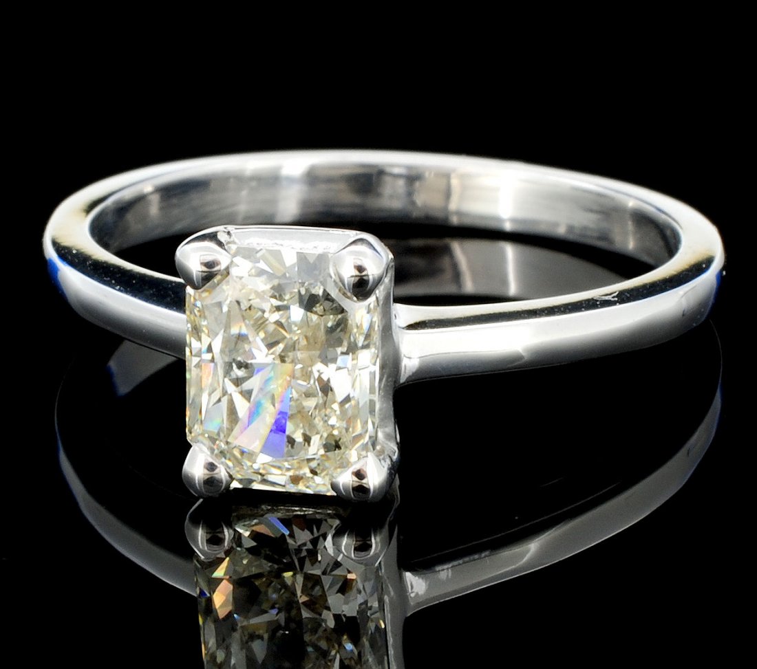 18K White Gold 1.01ct Diamond Solitaire Ring: Estimated Retail: $14,700.00 Ref: WAG5880 Main Gemstone: Diamond Shape: Rectangular Cut Cornered Weight: 1.01ct Color: K Clarity Grade: SI2