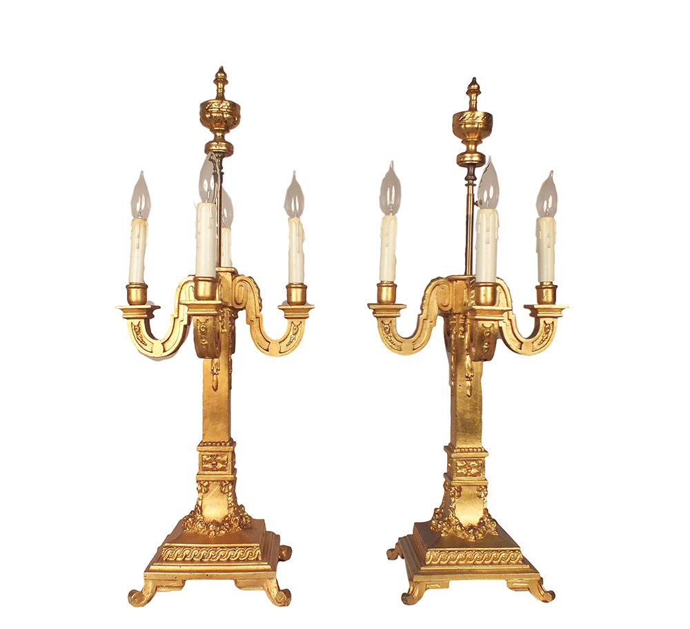 Italian Gilt Candelabra Lamps, Pair: Pair of four-arm Italian candelabra table lamps with a gold-leaf finish. Decorated with floral designs, candlestick bulb holders, and adjustable height harps. Wired and in working condition. Use 75W b