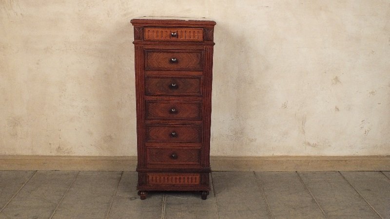 Antique French Nightstand: Elegant 1910's nightstand with beveled marble top covered rosewood veneers. The beautiful piece has 4 drawers accentuated with beautiful moldings. Middle portion opens up to small marble compartment. 