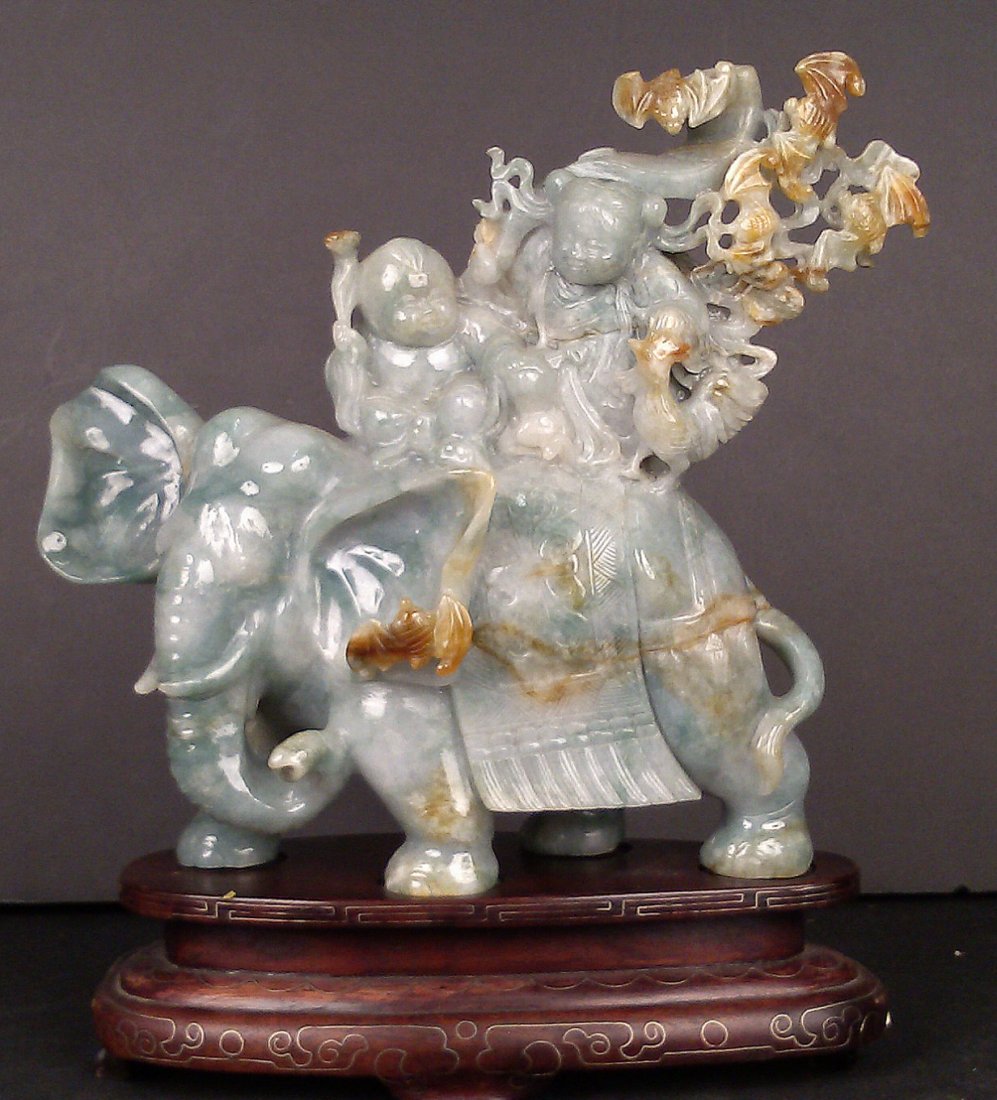 LAVENDER JADEITE BOY & GIRL ON ELEPHANT: Lavender Jadeite Boy and Girl on Elephant, masterfully carved Lavender Jadeite of a boy and a girl riding on elephant with rooster and bats. Bats are flying behind the girl on branches and is craved o