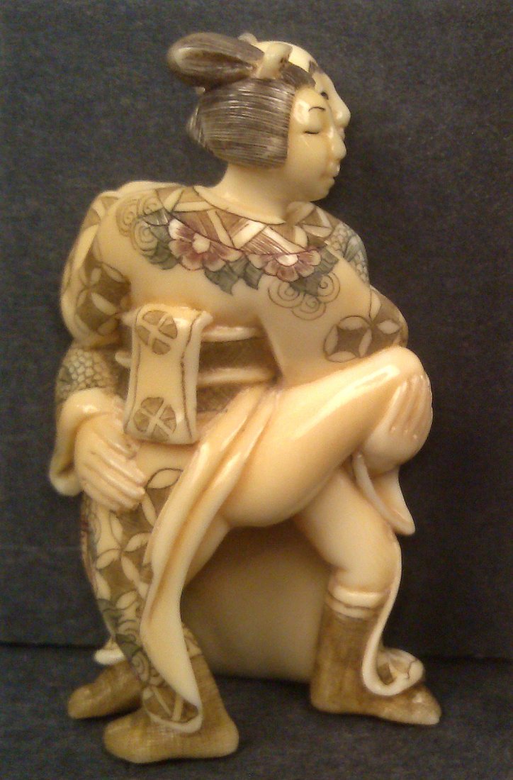 A hippo ivory carving netsuke of erotic group: A hippo ivory carving netsuke of erotic group in great details and skillful painting over individual incised lines. 2.3/8"H x 1.3/8"W (510434)