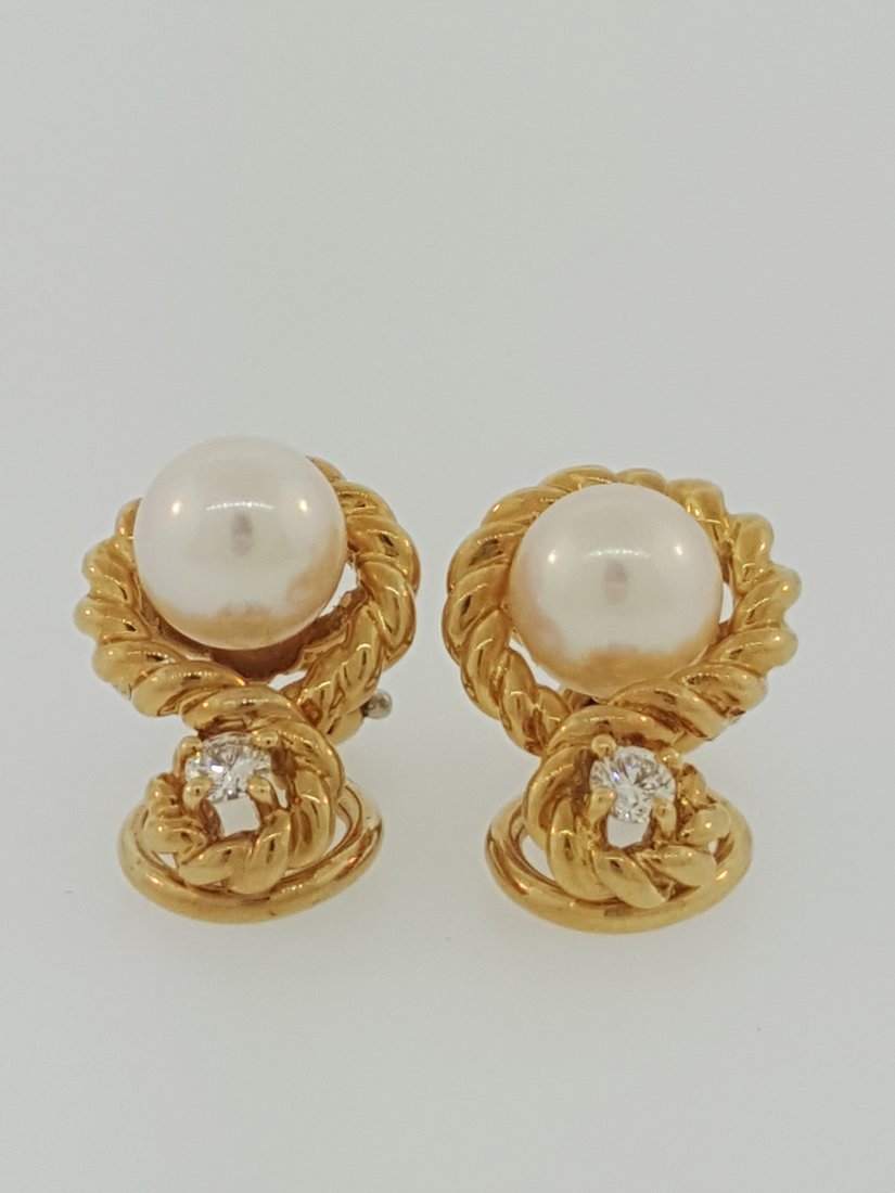 A Tiffany & Co. 18k Gold Akoya Pearl and Diamond: A Tiffany & Co. 18k gold rope design with snap back style earrings, set with Akoya pearl from Japan 6.8mm, and 0.20 carat total diamond weight.