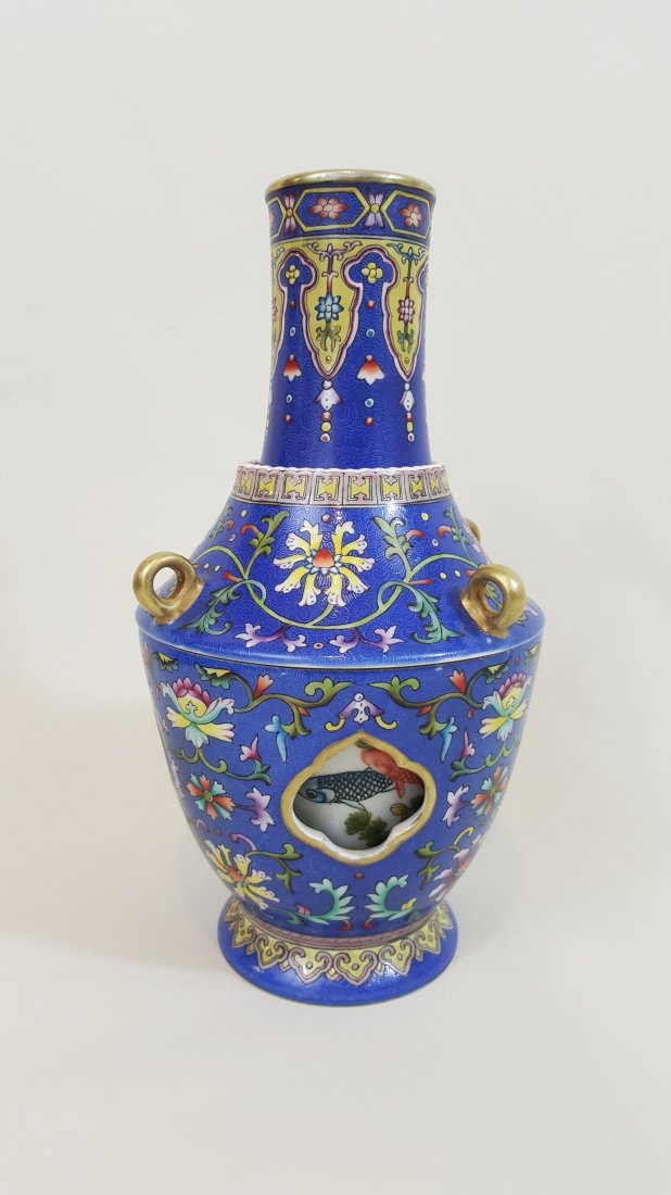 A Qing 3 piece blue vase- Qianlong: A Qing dynasty exotic porcelain blue vase with three removable parts; decorated with gilt looped handles, incised and enamel hand painted with florals and fish pond drawings over the white sectioned b