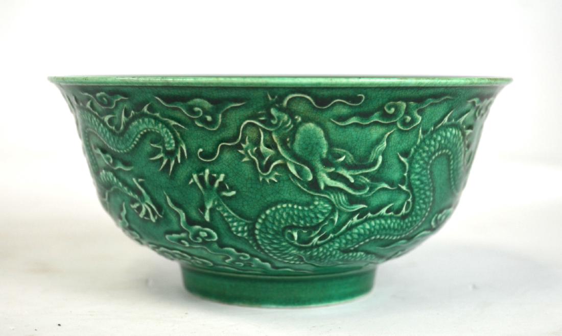 Chinese Green Glazed Bowl: Chinese green glazed porcelain bowl decorated with three dragons. Impressed six-character mark on the bottom. 3" H x 6 1/4" dia