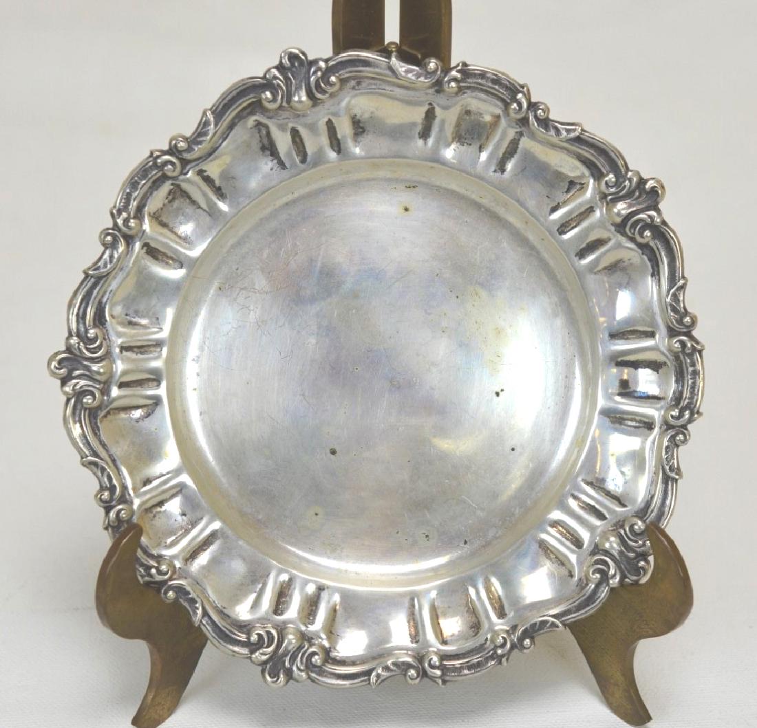 Sterling Silver Dish with Scrolling Rim: A sterling silver dish with a scrolling decorated rim. Marked "800" on bottom as well as "EM" and "52 M" marks. Diameter - 5 1/2"