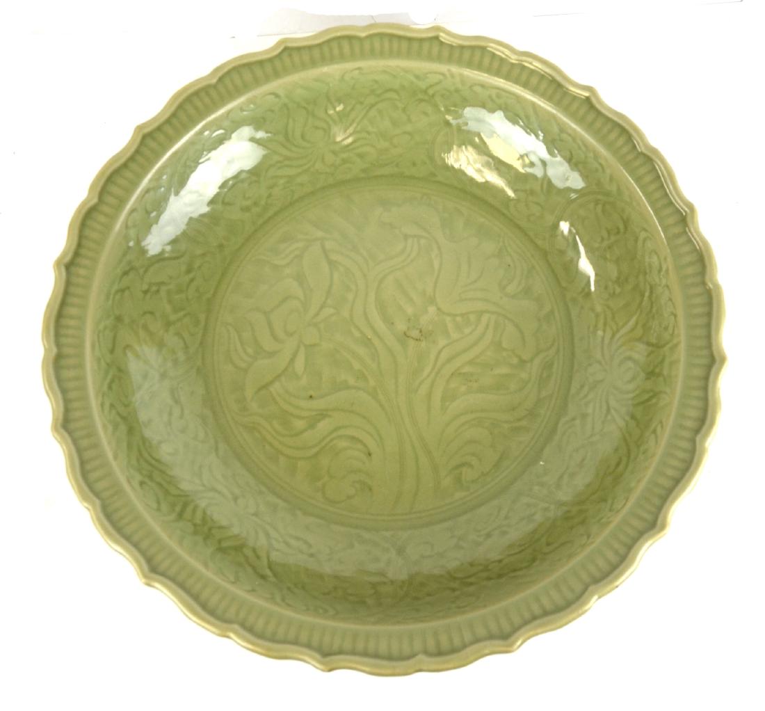 Chinese Large Celadon Longquan Glazed Charger: Large Chinese Longqun celadon glazed lotus form charger carved with floral design, Ming Dynasty. 18 1/2" x 4 3/8"