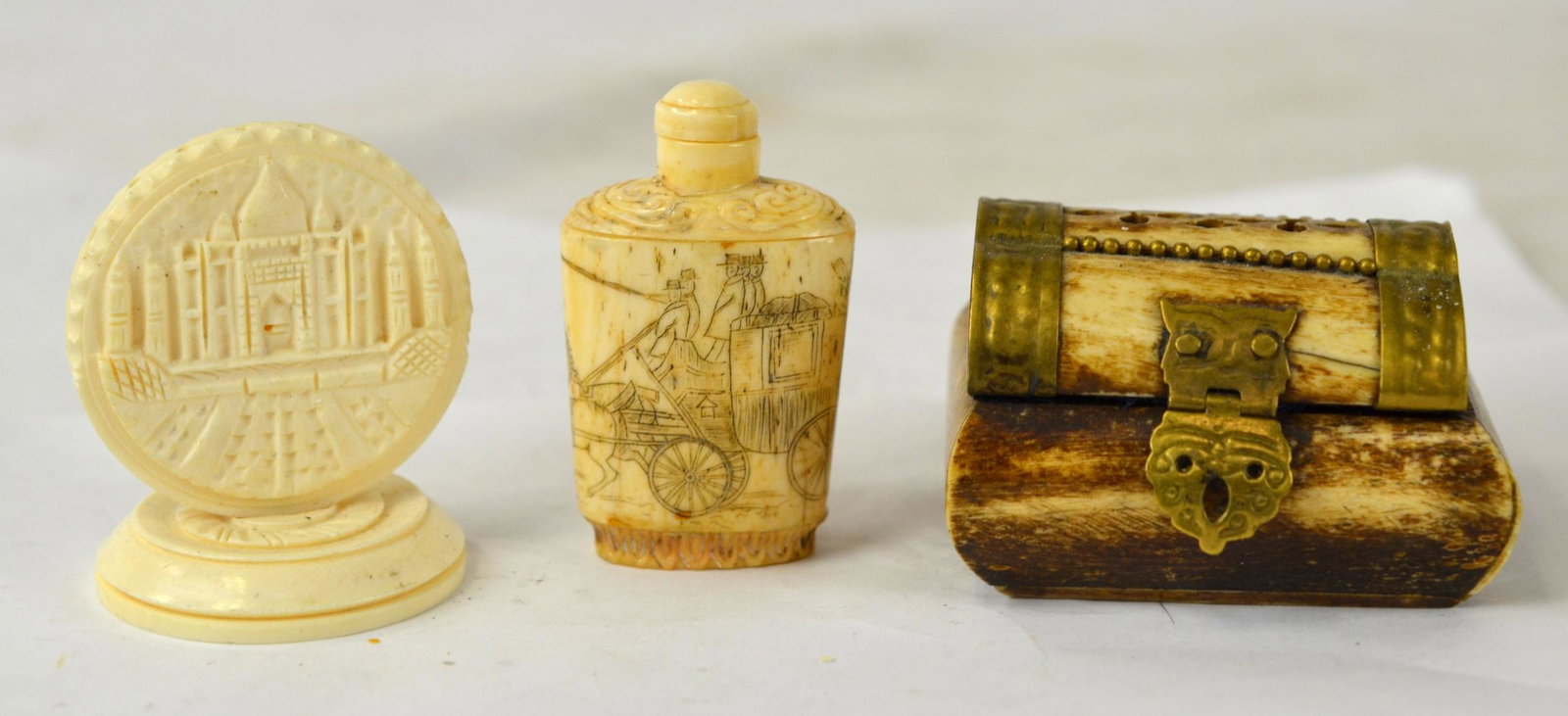 Three Pcs of Carved Objects: Three pieces of carvings including a Chinese carved snuff bottle. 2 3/8"H x 1 1/2"W, a copper mounted box . 2 3/4"W x 1 3/4"H, and a bone carved piece. 2"W x 2 1/4"H