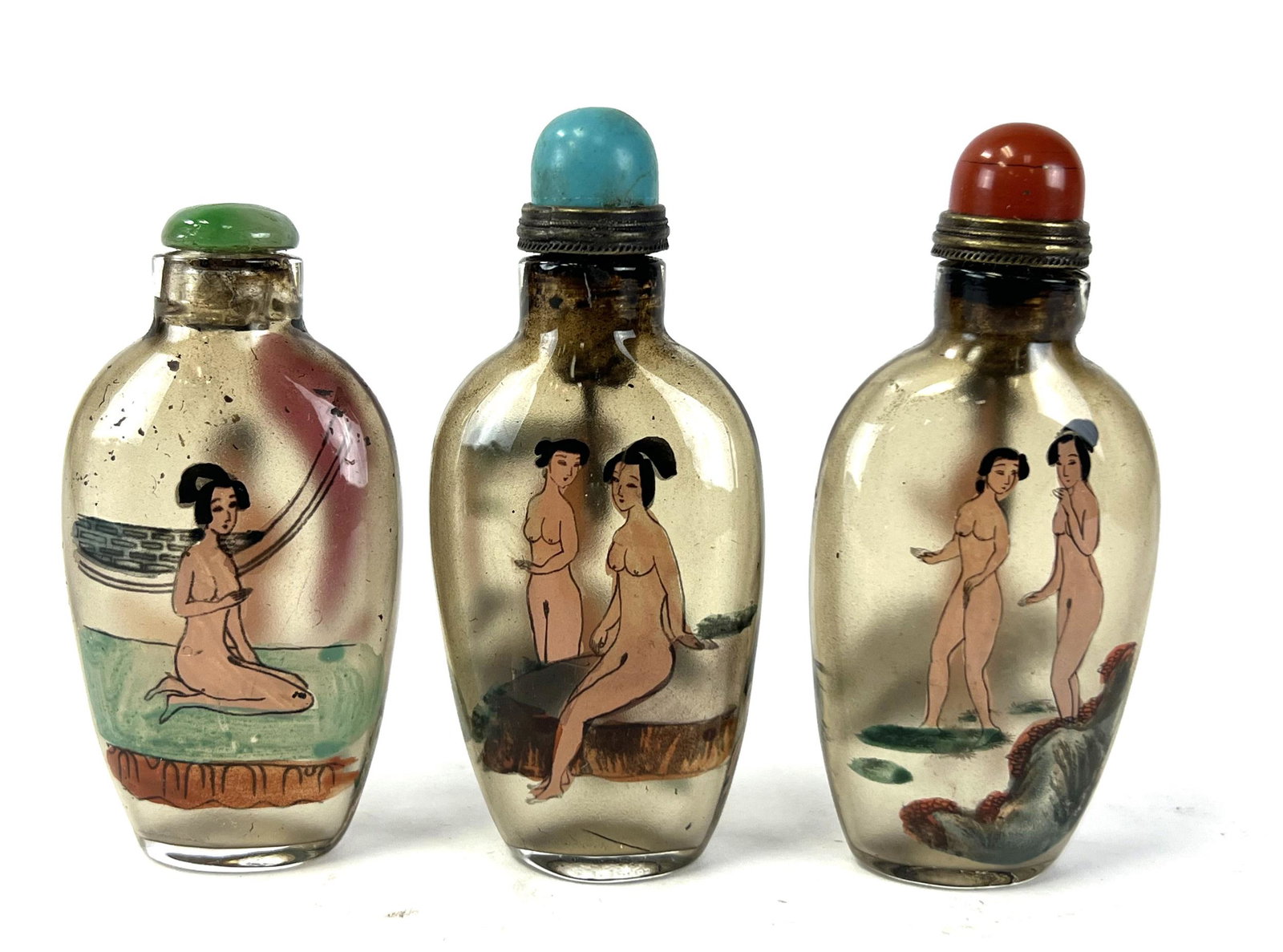 Three Reverse Painted Perking Glass Snuff Bottles: 19/20th century. Three Perking glass snuff bottles with stopper. each with reverse painted erotic figures. tallest is 3 3/8"H, and shortes is 3"H