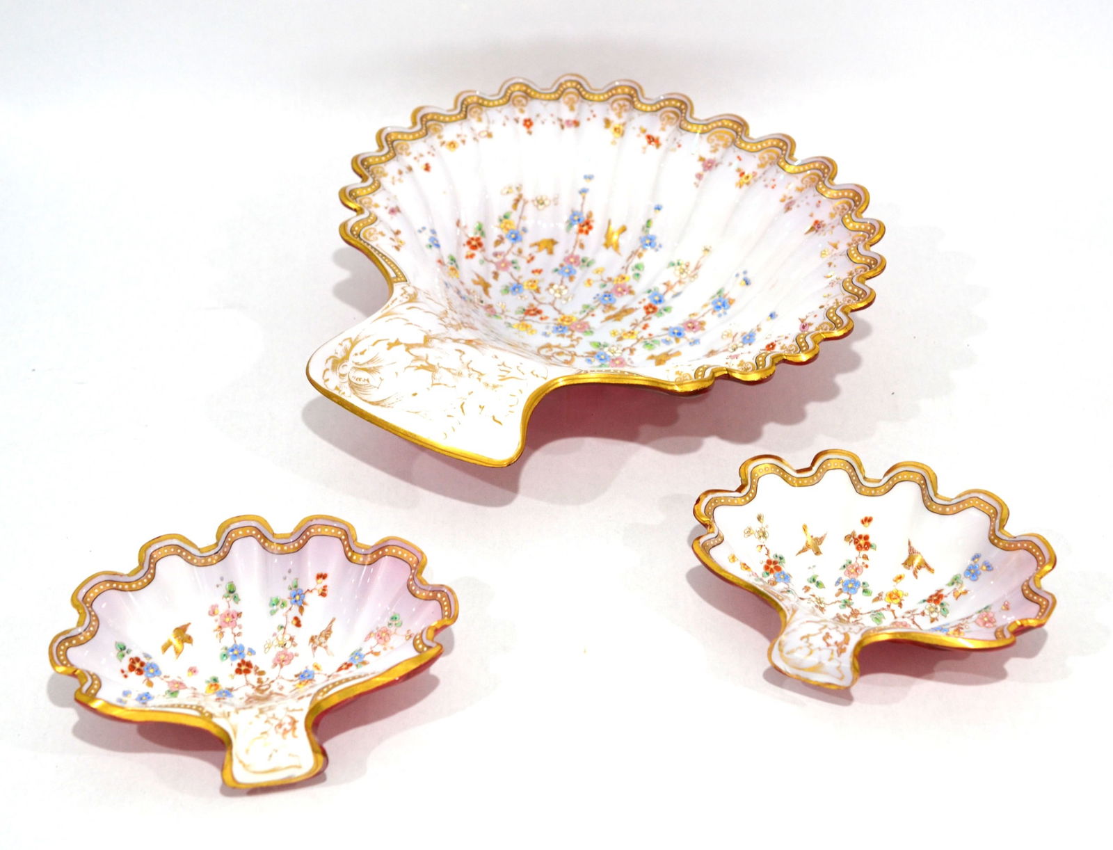 Set of Three Opaline Glass Shell Dishes: Mid 19th century. Three pieces of Bohemian opaline glass cranberry cased shell shape dishes with polychrome enamel. two are same size: 6 1/2"W x 5"D x 1 5/8"H, and larger one is 10 3/4"W x 10 3/4"D x