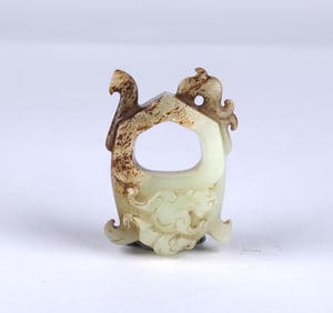 An Archaic Celadon Russet Jade Carving