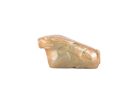 An Archaic Celadon Russet Jade Buffalo