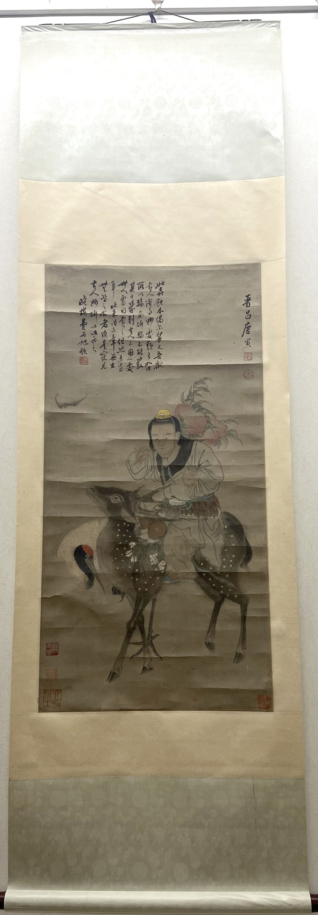 Attributed To Tang Yin, Immortal, Crane & Deer: An old Chinese painting depicting an immortal was riding on a deer and holding two large peaches on the back, a crane stand next to them. 38 1/4"H x 19 5/8"W from Huntington Long Island estate.