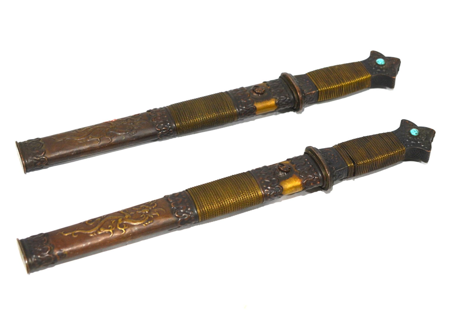 Pr Asian Style Brass Daggers: Pair of Asian brass daggers with turquoise bead inlaid on end of handle and with relief dragons on scabbard. each is 14"L