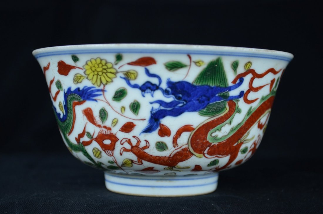 A Small Chinese Famille Verte Dragon Bowl: Wanli Six-Character Mark in underglaze blue and of the period. Two beautifully painted colorful dragons decorate this bowl with a double lined border and flower and leaf design on the bottom of the in