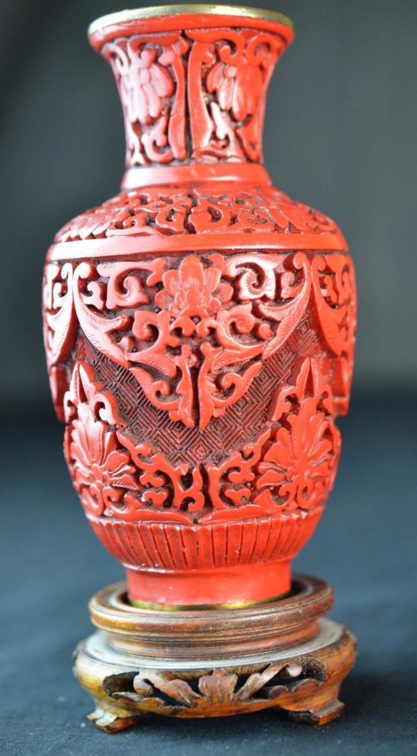 A Chinese Carved Cinnabar Vase: Carved Chinese cinnabar vase. Unmarked. 6"x 3" dia.