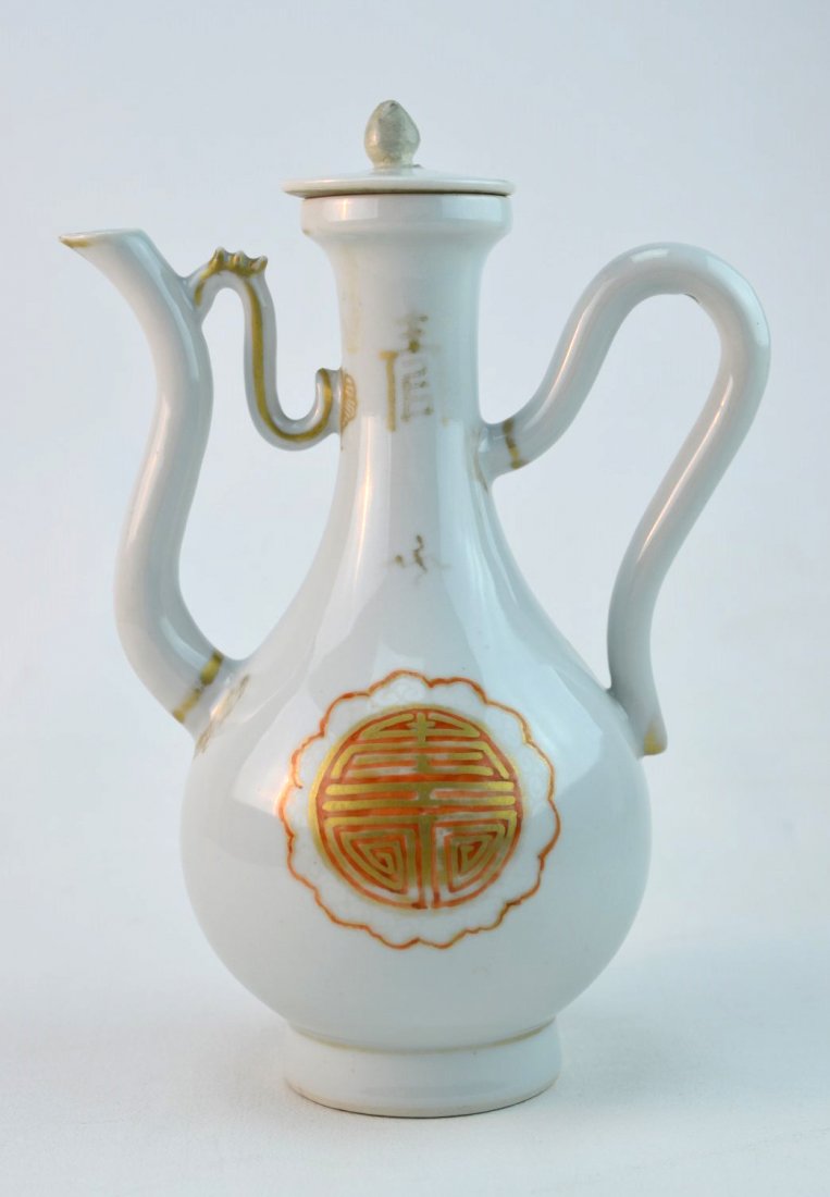 Chinese Porcelain Wine Pitcher: Chinese porcelain wine ewer painted in copper red and gold with Chinese symbols, Qianlong Period. Repair to finial, nick to edge of lid. 7 1/2" x 5 3/4"