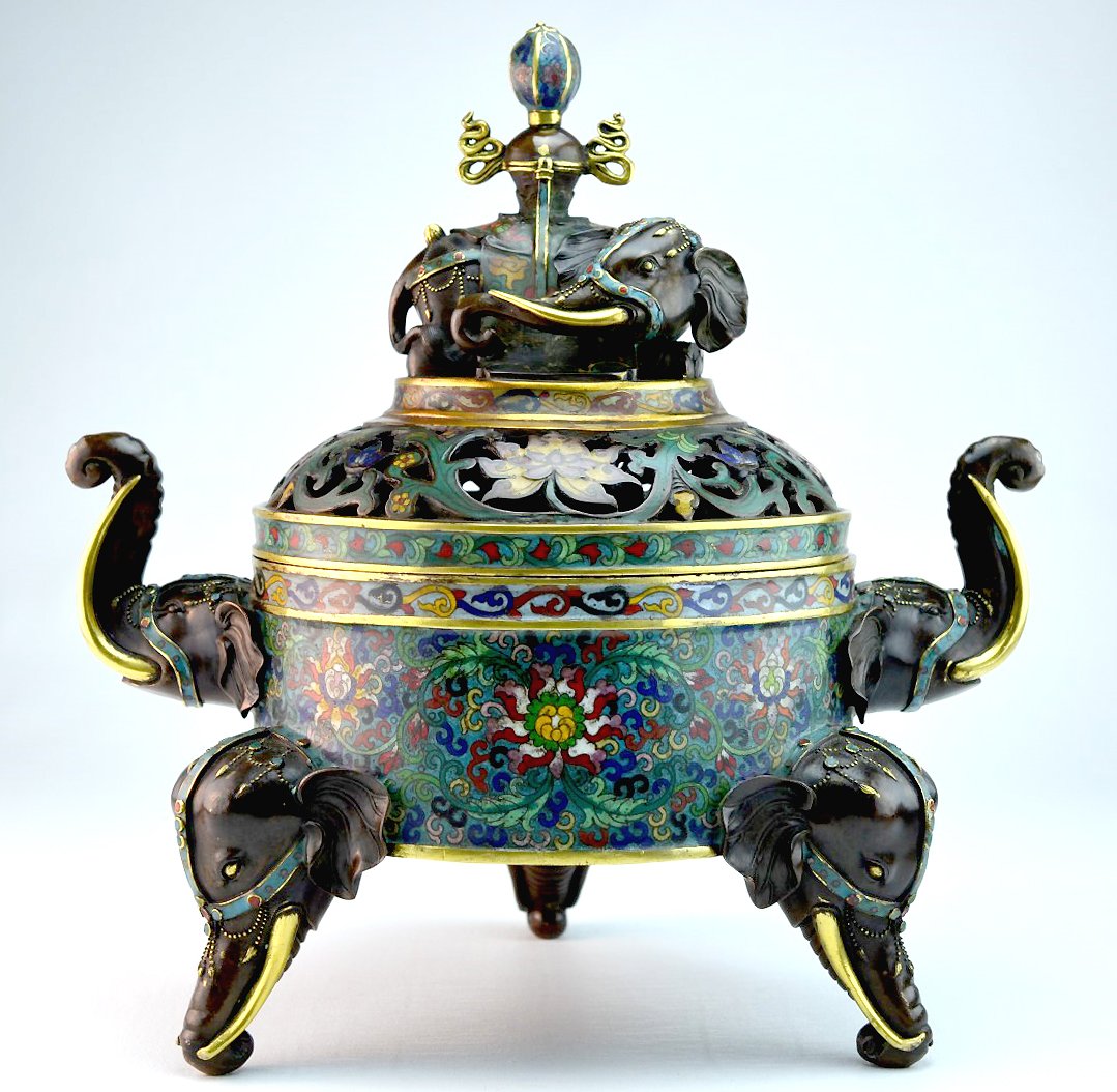 Large Chinese Cloisonne Incense Burner: Large Chinese cloisonne incense burner with bronze elephant-head feet and handles, a bronze elephant lying atop the scrollwork lid, 19th-20th century. Four Chinese character mark. 14" x 13 3/4"