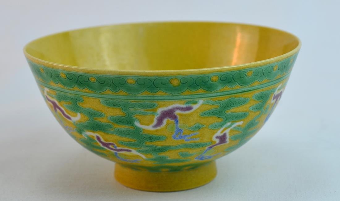 Chinese Green and Aubergine-Glazed Yellow-Ground: Chinese porcelain green and aubergine-glazed on yellow ground bowl, decorated with bats and clouds, 18th century. Black six-character mark. 3" x 6"