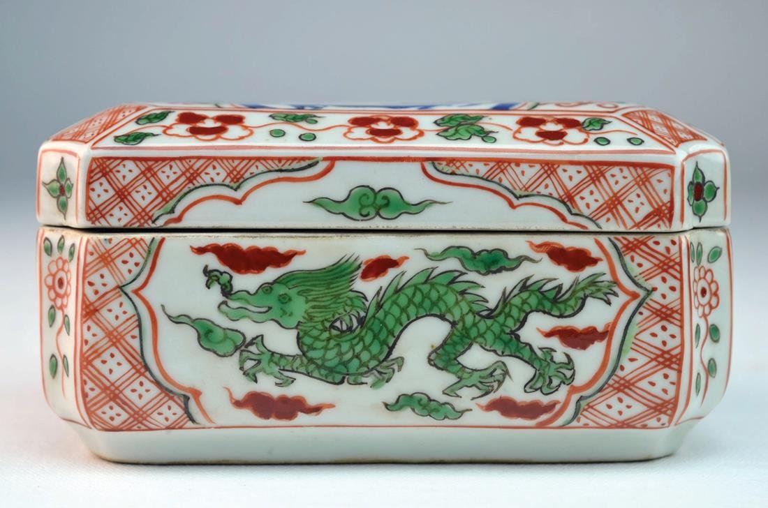 Chinese Porcelain Covered Box: Chinese porcelain Famille Verte covered box decorated with dragons in green and blue, with floral and stylized designs in copper red, 18th century Kangxi period. 3" x 5"