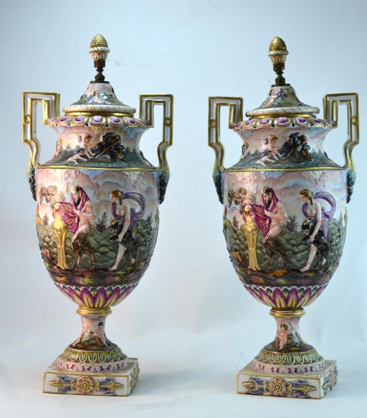Pair of Italian Porcelain Capodimonte Tall Urns: Pair of Capodimonte porcelain urns with mythological motifs painted in polychrome. Marked with a crown N. 22" each