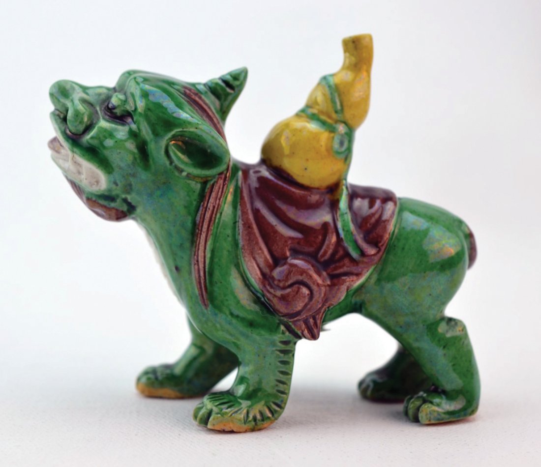 Chinese Porcelain Figure of Mythical Beast: Chinese porcelain figure of a mythical beast with a double gourd tied to its back, glazed in bright green, yellow, and brown, 20th century. 3 1/4" x 3 3/4"