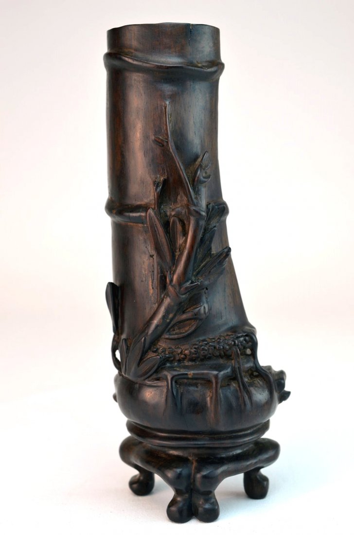 Chinese Hardwood Figural Carving / Armrest: A Chinese hardwood figural carving / armrest depicting a bamboo-form vase on footed base, the reverse side carved with crickets crawling up the interior of the "vase", 20th century. 9 1/2" x 3 3/4"