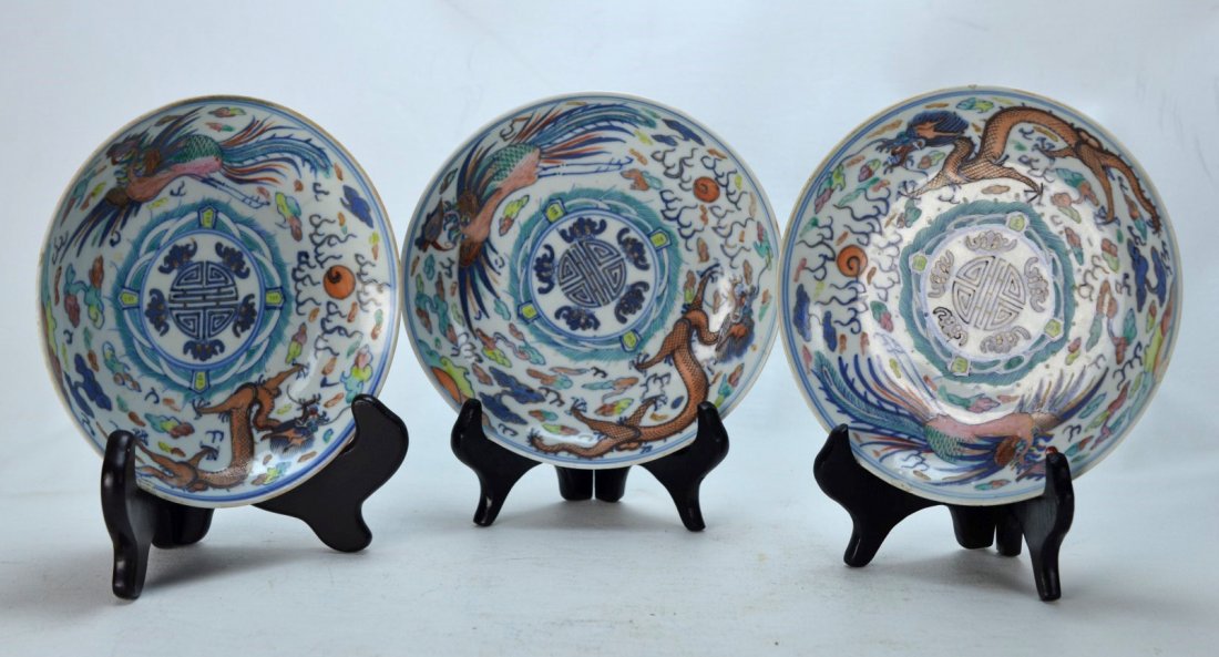 Three Chinese Plate Decorated with Dragons with Mark: CHINESE PORCELAIN Three plates painted with dragons, large bird-like creatures, and clouds, 19th century. A few filled-in chips and hairline. Underglaze blue six character mark. 1 1/2'' x 6 1/2'' dia.