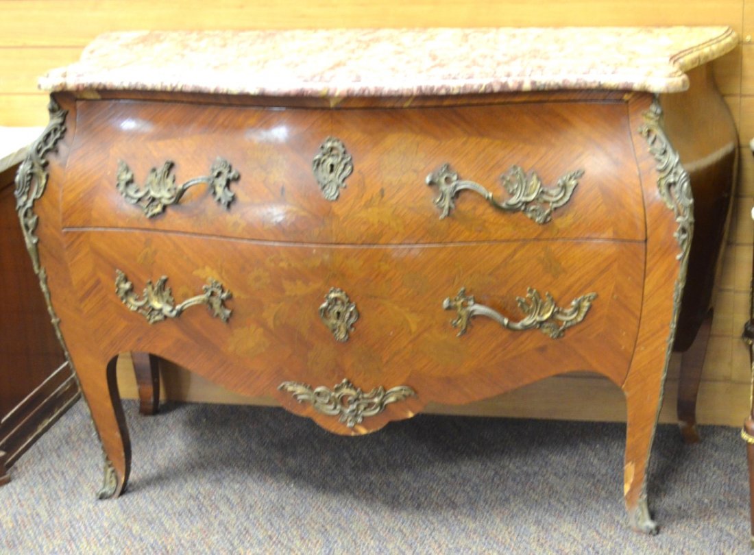 BOW-FRONT TWO-DRAWER CHEST: BOW-FRONT TWO-DRAWER CHEST The sides flanked with foliate ormolu fittings and handles, the drawers inlaid with floral design, topped by pink marble. Unmarked. 34'' x 50 1/2'' x 22''
