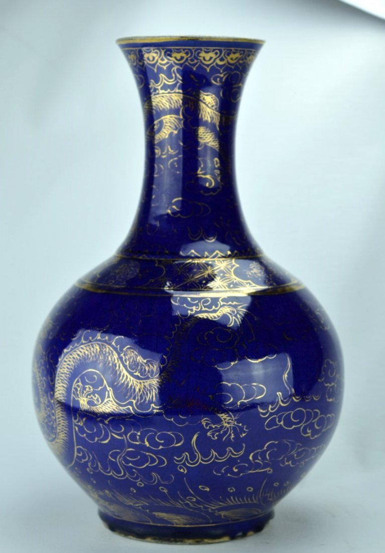 19th C Chinese Gilt Decorated Blue Glazed Bottle Vase: CHINESE PORCELAIN Spherical vase with long flaring neck, decorated with gilded dragon design against a bright blue ground, 19th century. Character mark on bottom, clean 1/2'' drill hole through mark. 
