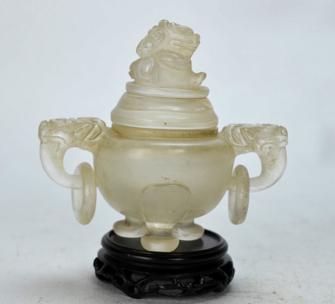 19th C Carved Chinese Rock Crystal Censer with Lid: CHINESE CRYSTAL Footed censer with foo dog perched atop lid, and two foo dogs holding ring handles on each side, atop a carved wood base, 19th century or earlier. 5'' x 4 1/2'' with base, 4'' without 