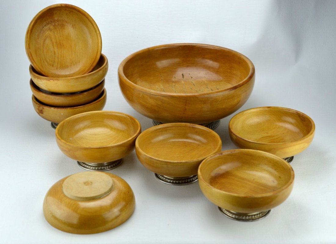 STERLING SILVER Ten-piece hand-turned birch bowls: STERLING SILVER Ten-piece hand-turned solid birch bowl set with sterling silver foot, comprised of one larger bowl and nine smaller bowls. Wear to wood. Some marked with stickers indicating materials.