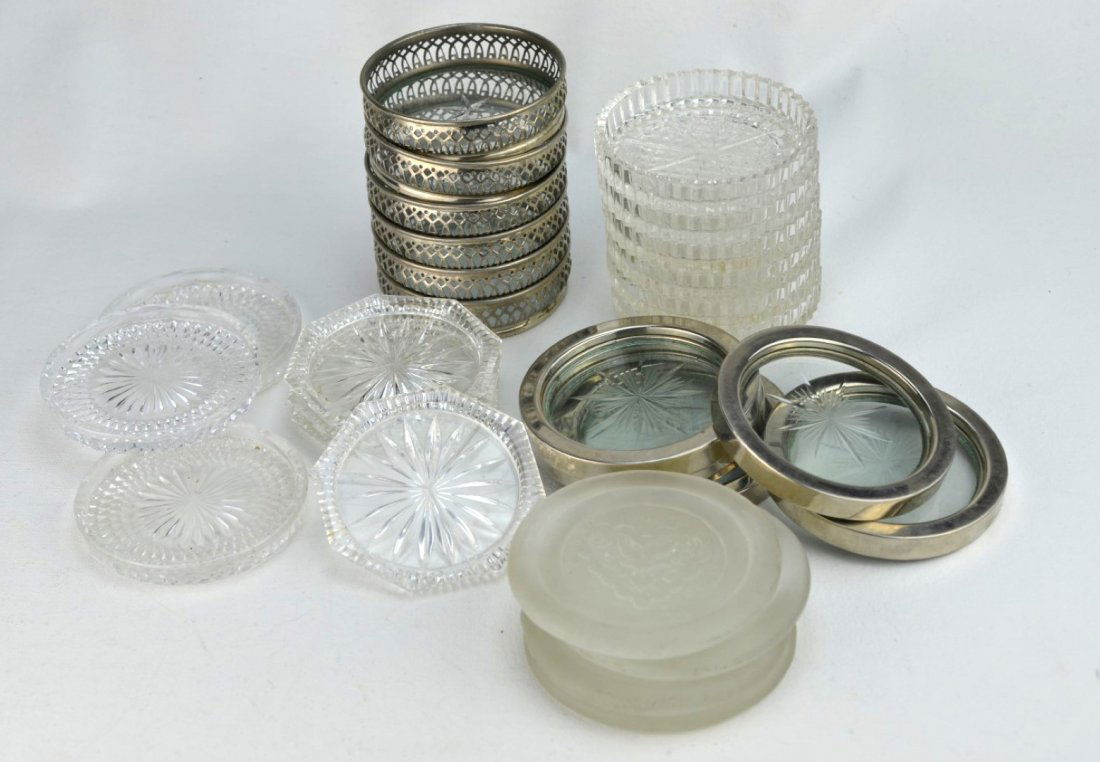 SILVERPLATE AND GLASS Twenty-eight coasters: SILVERPLATE AND GLASS Twenty-eight coasters; twelve cut or pressed glass with different patterns, four molded with bird within a heart, six with etched glass center and silverplate or metal rim, and f