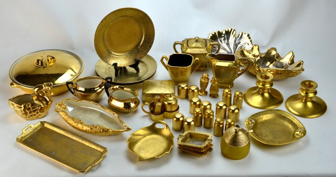 Large collection of gold painted porcelain: NORITAKE PORCELAIN Etc. Large collection of gold painted porcelain including a covered 9" dish, a pair of 3" candlesticks, a swan-shaped vessel (hairline), a leaf-shaped dish, 9" tray, three 2 1/2" as