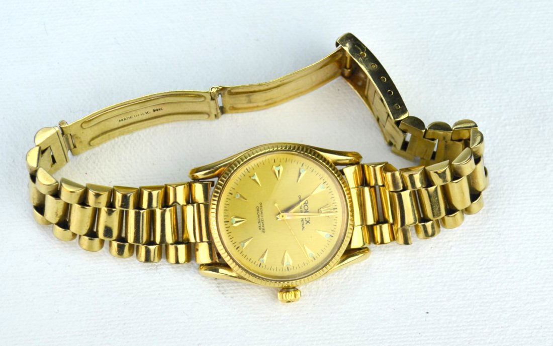 14k Gold Mens Watch Marked Rolex: Watch marked Rolex with 14k gold band. Face: 1 1/4", Band: 5 1/2". Band marked MADE IN HONG KONG 14K. Band not original to the piece, we believe the watch could possibly be a reproduction. From the co