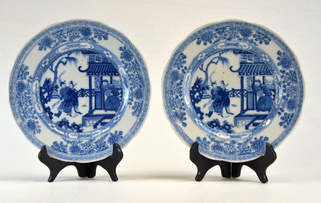 Pair of Chinese porcelain blue and white plates: Pair of Chinese porcelain blue and white plates, the centers painted with figures in a courtyard, the rim with banded design of swirls and flowers. Extremely tight line from rim and 1/2'' flat chip to