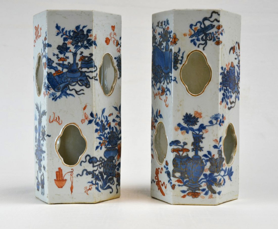 Pair of Chinese Porcelain Hexagonal Hat Stands: Pair of 19th century Chinese porcelain hexagonal hat stands painted in blue and copper red with vases of flowers and scrolls, the openings with gilded accents, 19th century. Underglaze blue six charac