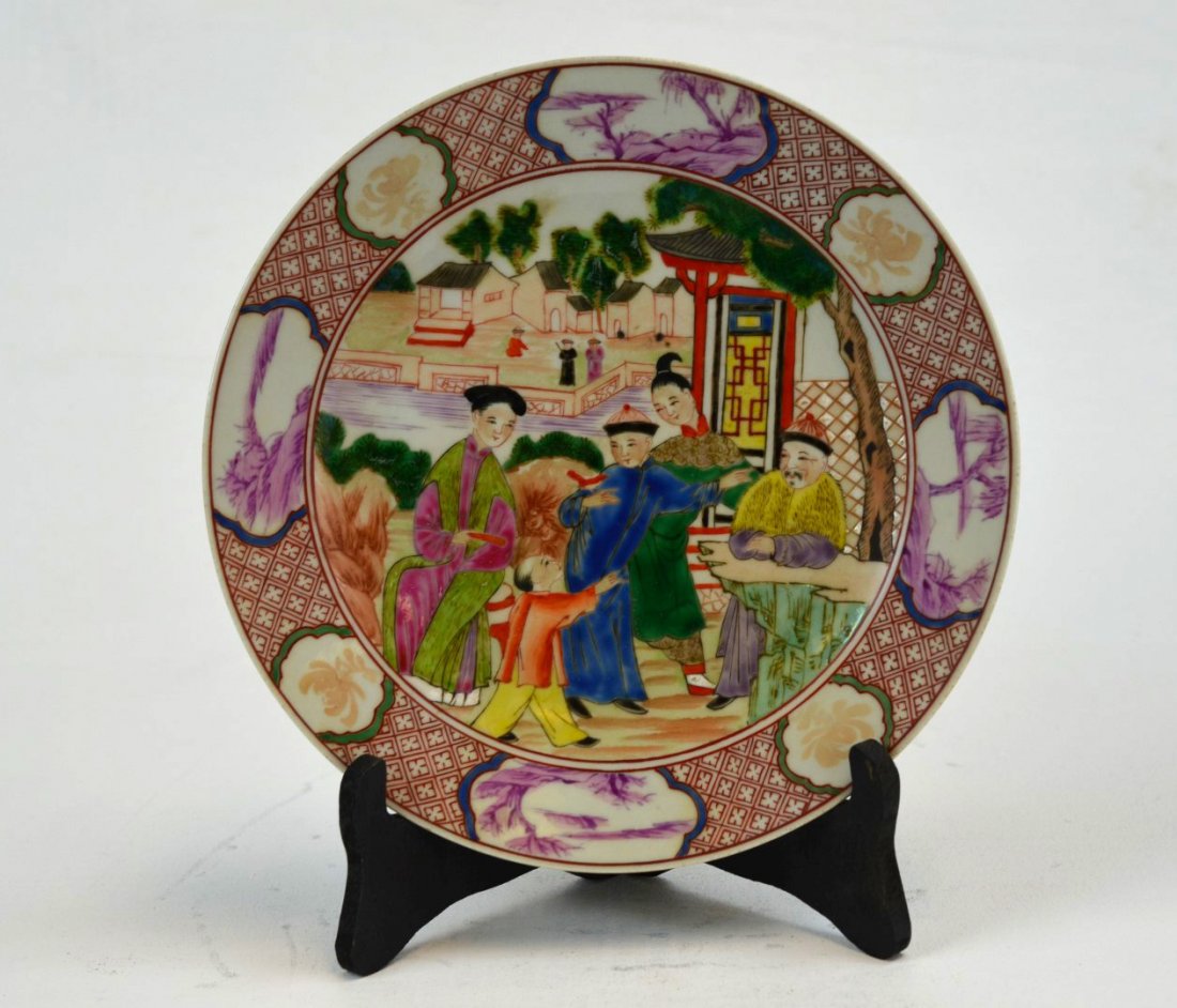 Qing Chinese Famille Medallion Plate: 18th century Chinese porcelain famille medallion plate painted with family gathering in a courtyard, the rim with medallions of flowers and trees along a rocky shore in purple and copper red. 1'' x 9'