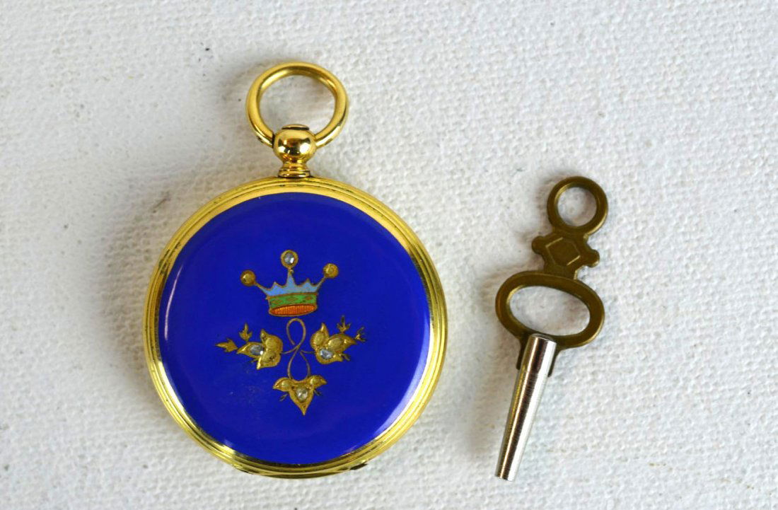 A. Breguet 18k Yellow Gold Pocket Watch: A. Breguet 18K yellow gold pocket watch with blue enamel case, with ribbon and flowers on one side, leaves and crown on the other. Engraved maker's mark, 18K. 16.3 dwt (24.7 g). 1 1/4'' dia.