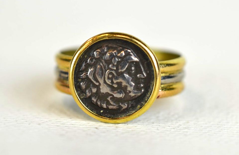 Antique 18K Gold & Silver Coin Ring: 18k gold and silver ring with small silver ''coin'', the band of striated gold and silver. 1.6 dwt. (2.5 gs). Unmarked. Coin: Approx. 1/2'' dia.