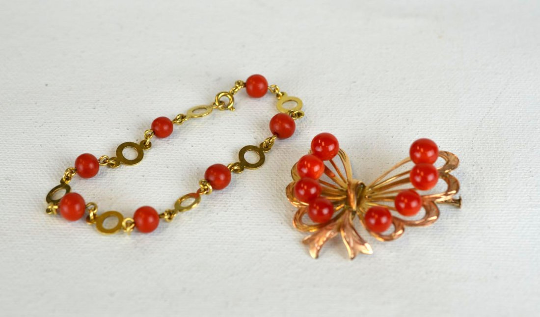 Pin and Bracelet of Gold and Carnelian (Coral): Bracelet of 14k gold, accented with circles of carnelian, with attached pin of 18k gold, crafted as a bow in the shape of a butterfly, 10.9 dwt (16.7 gs). Bracelet: 2 1/2'' diameter, Pin: 1 1/2'' x 1 