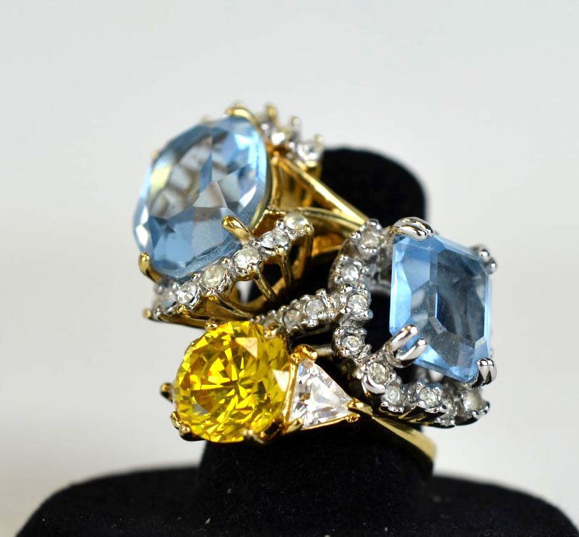 3 Gold or Gold-Plated Semi-Precious Gem Rings: Three rings of 18k gold or gold-plated with semi-precious stones in blue or yellow. 12.7 dwt. (19.6 gs). One marked. Largest: 3/4'' x 1/2''