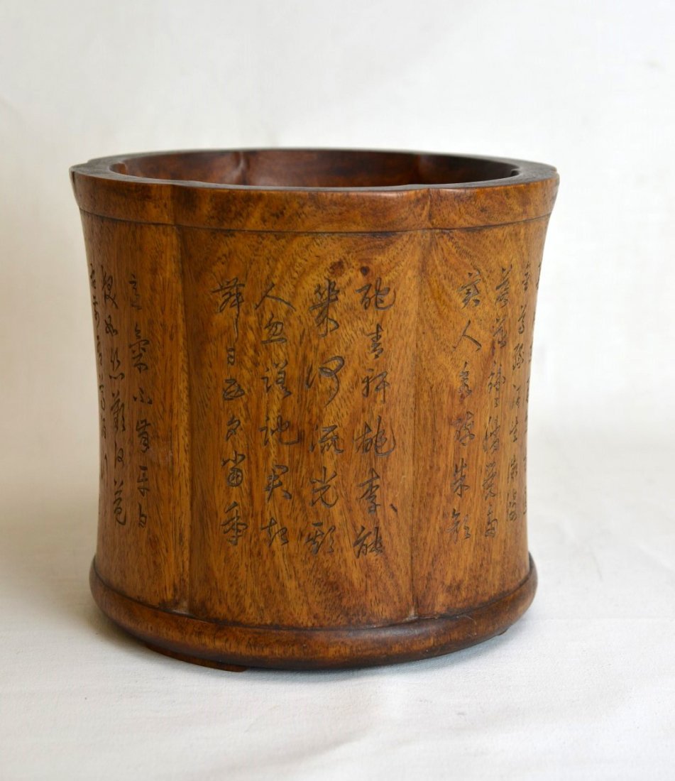 18th c. Huanghuali Lotus-Shaped Brush Pot: A Chinese lotus-shaped huanghuali brush pot with calligraphy etched around sides. 18th c. Height - 8 3/8" Diameter - 8 7/8"