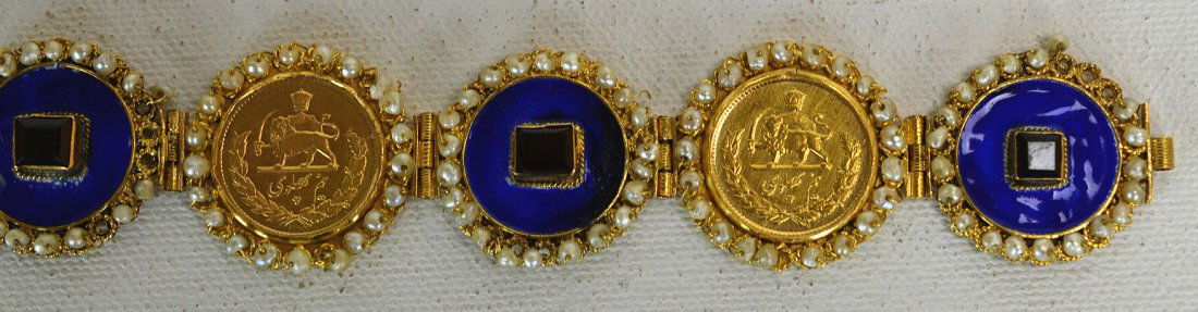 22k Gold Bracelet with Iranian Coins & Garnets: 22K Gold ladies bracelet with three Iranian gold coins, alternating with medallions of blue enamel, each with central garnet, all surrounded by seed pearls, and two rubies at the closure. Some damage