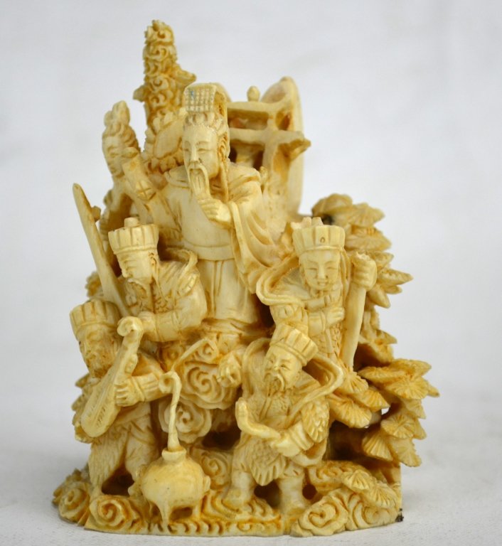 Chinese Antique Ivory Carving: A Chinese ivory carving of six men, some warriors, atop smoke, mountains, and trees. Height - 4" 19th century