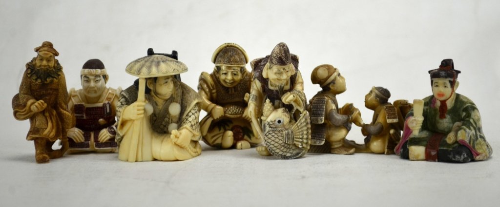 Seven Japanese Antique Ivory Samurai Netsukes: Seven antique ivory samurai netsuke; four are of seated samurai one of which is polychrome, one of a walking samurai (mammoth ivory), a samurai with a fish, and a samurai with his son. All marked. 19t