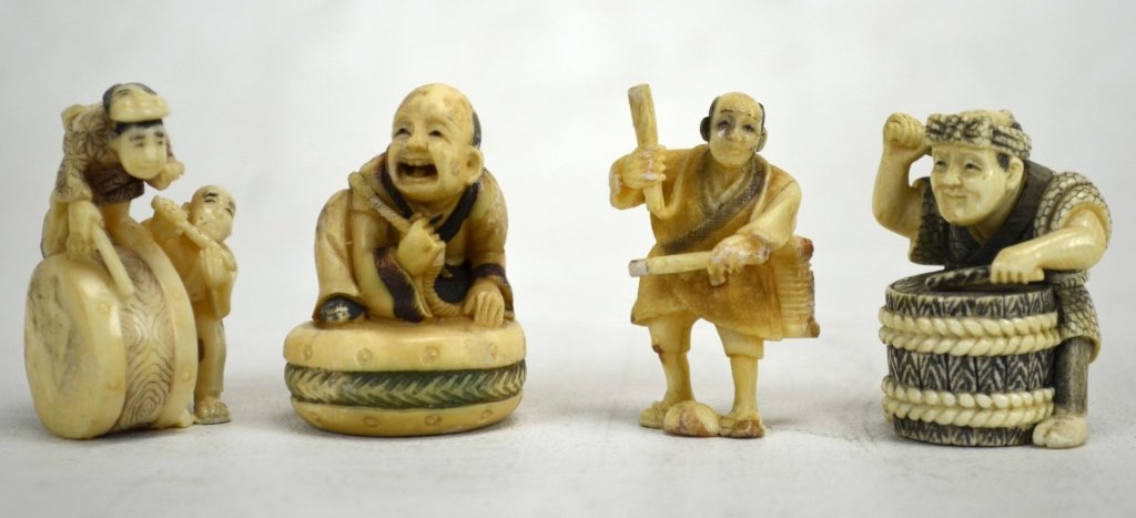 Four Japanese Antique Ivory Netsukes: Four antique ivory netsukes of men and drums. All marked. 19th century. Dimensions: Height of all - 1 7/8"